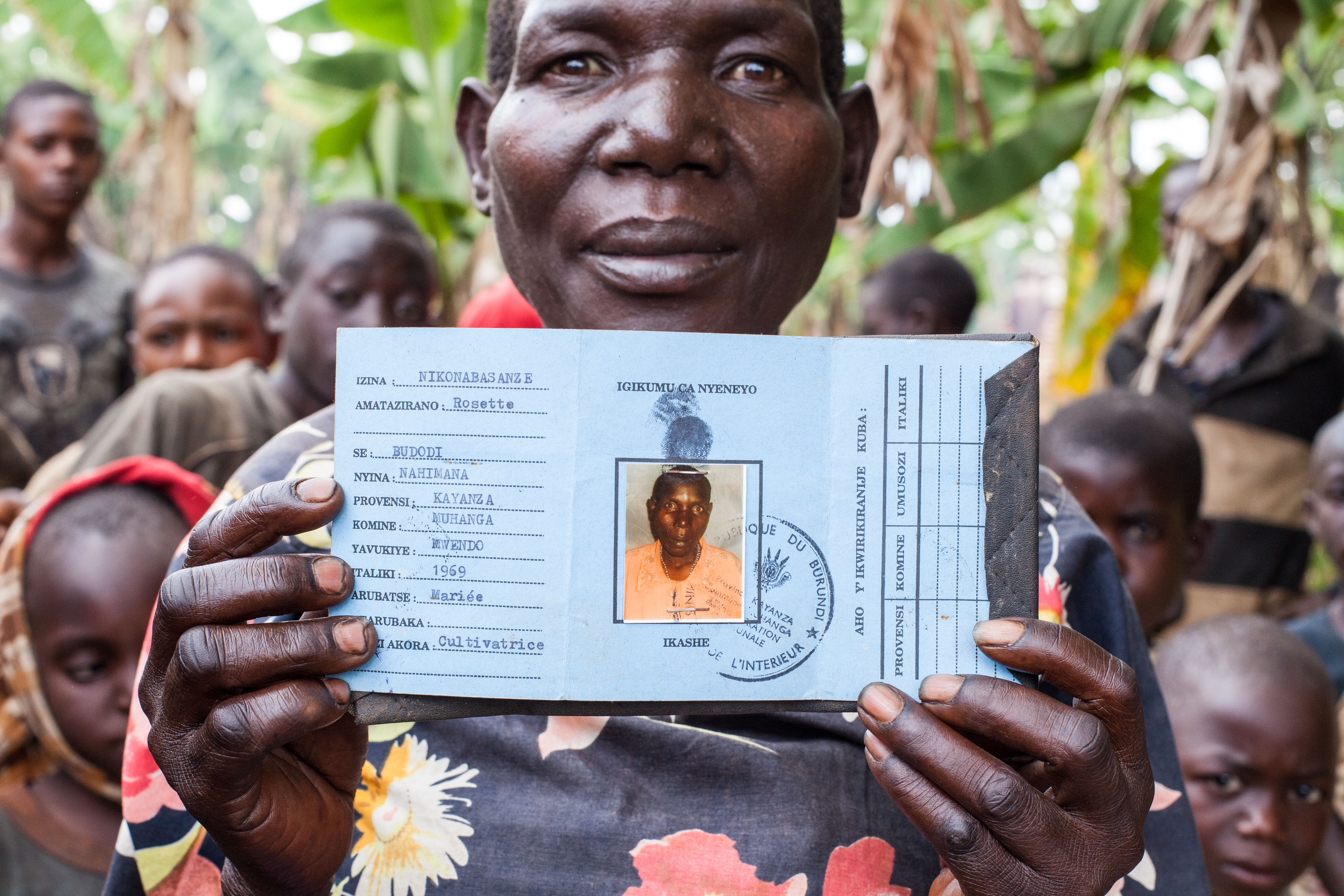 A woman smiling with her identification card